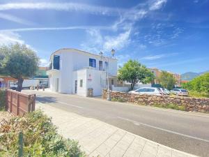 a white building on the side of a road at Casa Passeri in San Teodoro