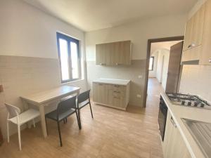 a kitchen with a table and chairs and a table and a stove at Casa Passeri in San Teodoro +17 photos