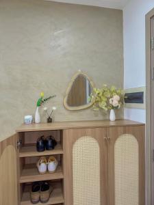 a dressing table with a mirror and a vase with flowers at Nera home, An apartment Huế in Thôn Văn Dương +55 photos