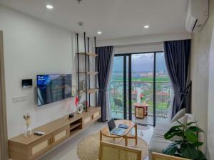 a living room with a couch and a tv at Nera home, An apartment Huế in Thôn Văn Dương