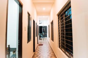 a corridor of a house with wine racks at The Last Stop Backpackers Hostel in Auroville