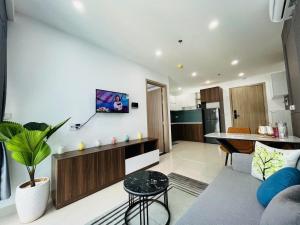 a living room with a couch and a table at Nera home, An apartment Huế in Thôn Văn Dương