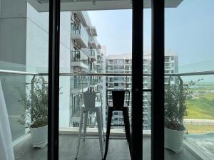 a chair sitting on a balcony with a view of a building at Nera home, An apartment Huế in Thôn Văn Dương