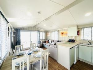 a kitchen and living room with a table and a couch at Beach Retreat in Filey