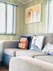 a couch with pillows on it in a living room at Beach Retreat in Filey