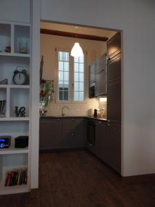 a kitchen with stainless steel appliances and a window at Valencia what else... in Valencia +14 photos