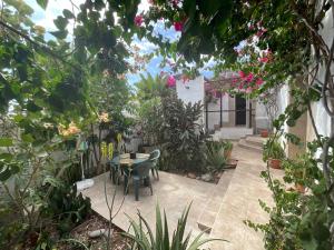 a patio with a table and chairs in a garden at Casa Tijoco in Adeje