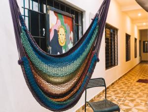 a hammock hanging on a wall in a room at The Last Stop Backpackers Hostel in Auroville
