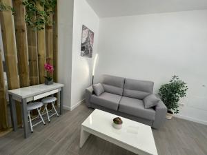 a living room with a couch and a table at Holliday 1 La Cala in Cala del Moral