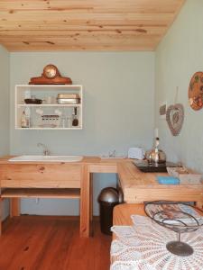 a kitchen with a wooden desk and a sink at The Wild Olive Sanctuary Accommodation in Paterson +70 photos