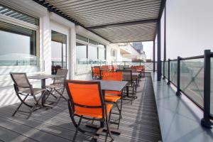 a row of tables and chairs on a balcony at Hôtel La Petite Sirène Quiberon in Quiberon