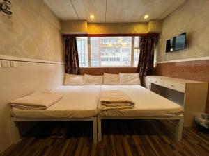 Voodi või voodid majutusasutuse 3D Inn Hong Kong Romance toas