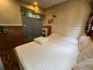 Voodi või voodid majutusasutuse 3D Inn Hong Kong Romance toas