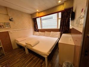 Voodi või voodid majutusasutuse 3D Inn Hong Kong Romance toas