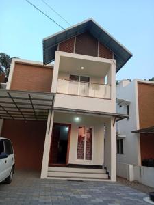 a house with a car parked in front of it at Fully furnished 3BHK 2 Floor Villa in Angamali