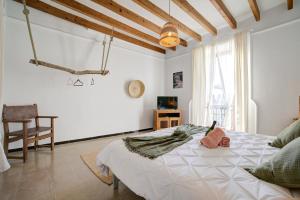 a bedroom with a large white bed in a room at Hotelet Can Oms Chopin by Rentallorca in Petra