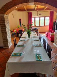 a large long table in a room with tables and chairs at Al Boschetto in Melizzano +23 photos