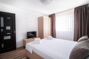 Postel nebo postele na pokoji v ubytování Nice & Cozy Sulina