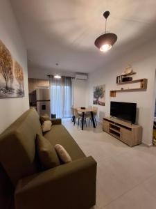 a living room with a couch and a table at Markella's apartment Karystos in Karistos