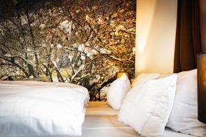 a bedroom with two white pillows and a wall mural at Alpine Hotel by SnowWorld in Landgraaf