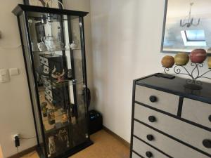 a room with a dresser and a glass cabinet at Magnolia in Namur