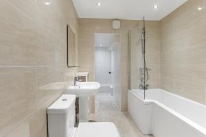 a bathroom with a sink and a toilet and a bath tub at The Hamlet - North East Escapes in Tynemouth +9 photos