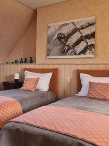 a bedroom with two beds and a picture of a skeleton at gite au jardin de grand-père in Fougères-sur-Bièvre