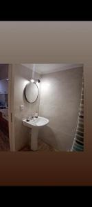 a bathroom with a white sink and a mirror at DREAM ROOMs in Nea Kallikrateia