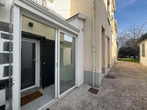 a sliding glass door on the side of a building at FRENCH KlSS - Love Room by PRIM0 C0NCIERGERIE in Clermont-Ferrand