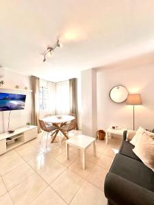 a living room with a couch and a table at Apartamentos J&K in Torremolinos