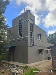 a large gray building with windows on the side of it at BNS Village Resort in Kolli Hills +28 photos