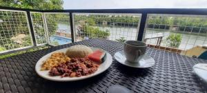 a plate of food and a cup of coffee on a table at Abucana Camp in Bucana