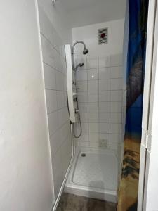 a bathroom with a shower with a toilet and a sink at Tamaris 42 in Quend-Plage