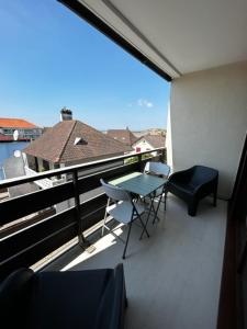 a balcony with a table and chairs on a balcony at Tamaris 42 in Quend-Plage