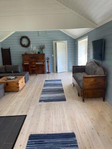 a living room with a couch and a table at Recently Refurbished Farm House in Larvik