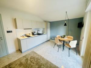 a kitchen with a table and chairs in a room at Appartamento Maison Sabrina con vista giardino in Borgofranco dʼIvrea