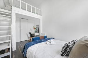 a white bedroom with a bunk bed and a desk at Le Cocon - Studio Proche Disney & Paris - Wifi in Lagny