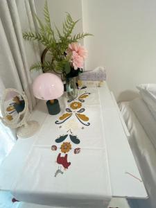 a table with a white table cloth with flowers on it at ReimiMondo 303 in Tokyo