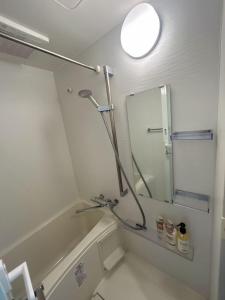a bathroom with a shower and a mirror at ReimiMondo 303 in Tokyo