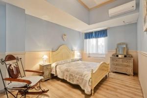 A bed or beds in a room at La Bouganville Holiday House