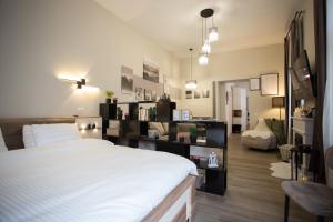 a bedroom with a large bed and a living room at Sinaia Escape Studio in Sinaia