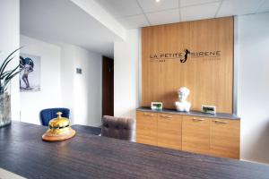 a conference room with a table and a sign at Hôtel La Petite Sirène Quiberon in Quiberon