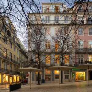 a tall building with umbrellas in front of it at Antiga Casa Pessoa in Lisbon