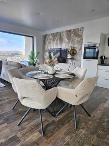 a dining room with a table and chairs at Wohnung mit großer Terrasse und Stadtview in Bad Berleburg