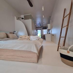 a bedroom with a large bed and a ladder at Vaios Luxury Apartments in Polykhrono