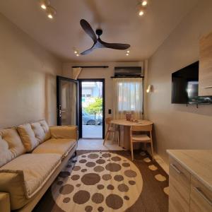 a living room with a couch and a table at Vaios Luxury Apartments in Polykhrono +6 photos