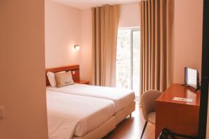 Postel nebo postele na pokoji v ubytování Vitoria Hotel + 37 fotografií