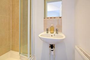 a bathroom with a sink and a shower at Hot Tub Stay Near Windsor & Legoland Sleeps 14 in Windsor +30 photos