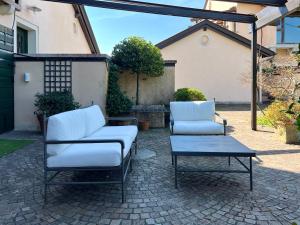 two chairs and a coffee table on a patio at Terme Colli Golf - Suite La Montecchia in Montecchia