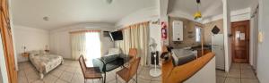two pictures of a kitchen and a living room at Study with balcony 'Tía Moni Alojamiento' in Colón +3 photos